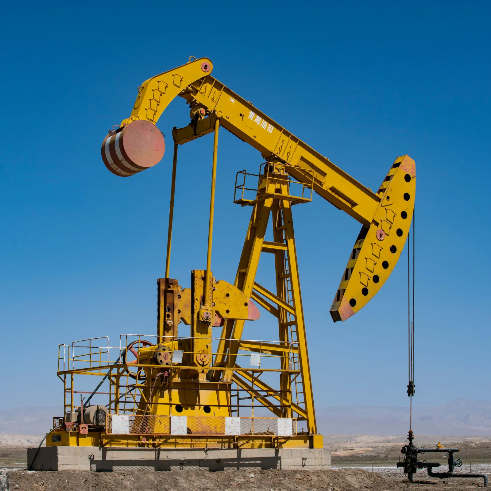 Oil pump jack against a clear sky