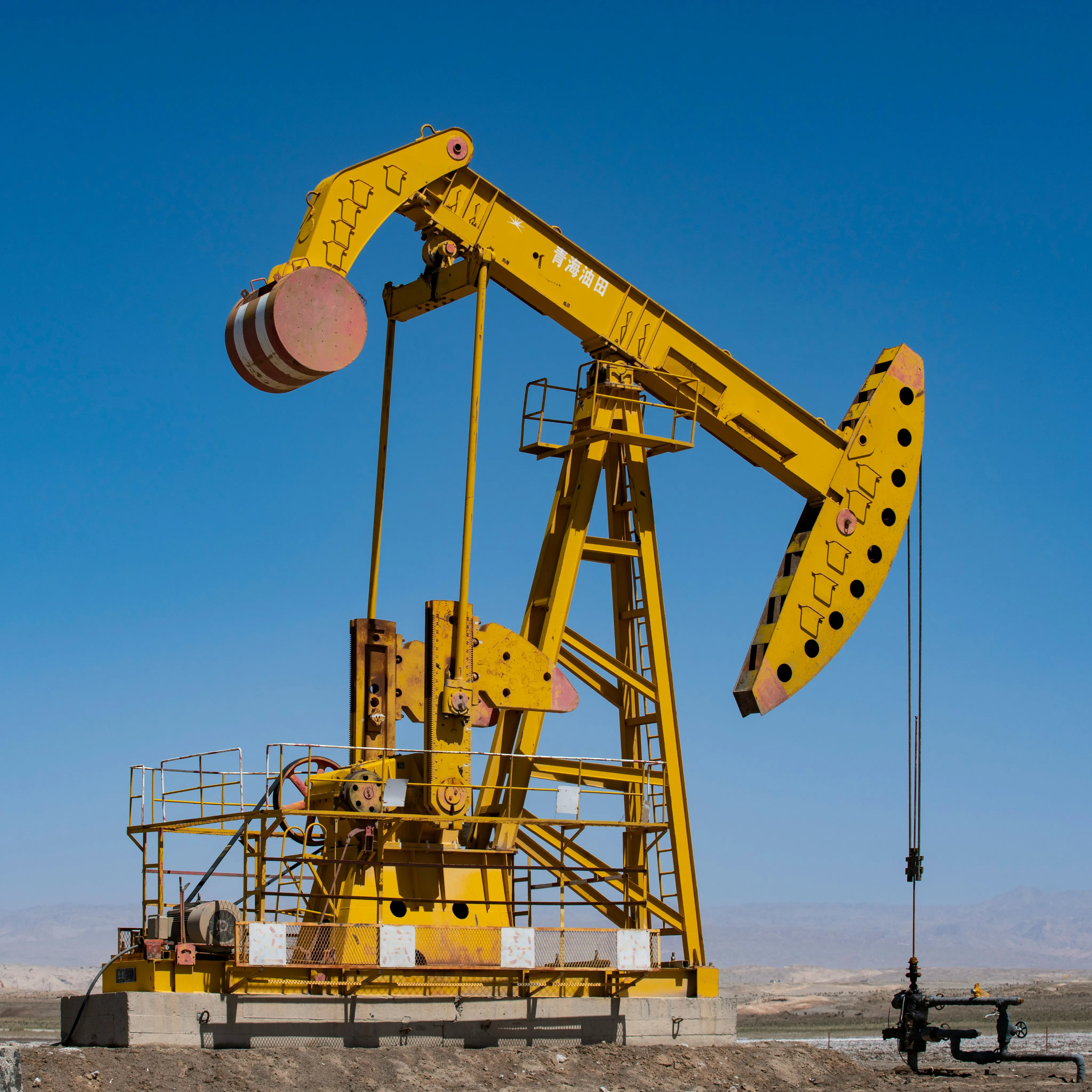 Oil pump jack against a clear sky